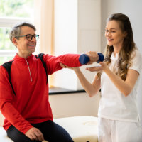 caregiver assessing the elderly man to exercise