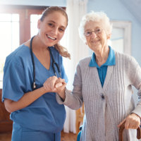 caregiver and elderly woman smiling