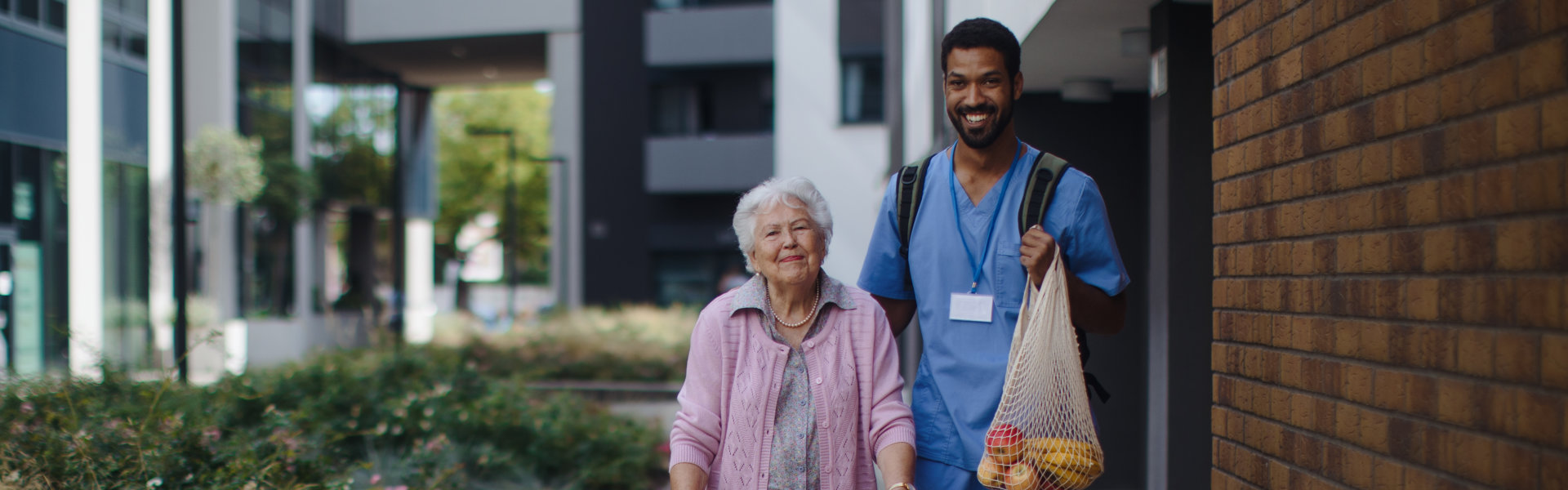 Caretaker helping an elderly woman