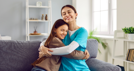 caregiver hugging young teen