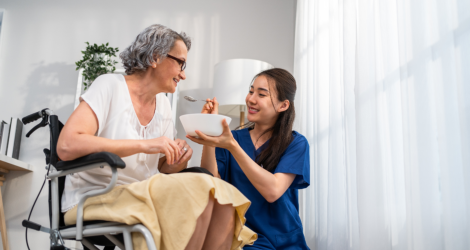 caregiver feeding senior