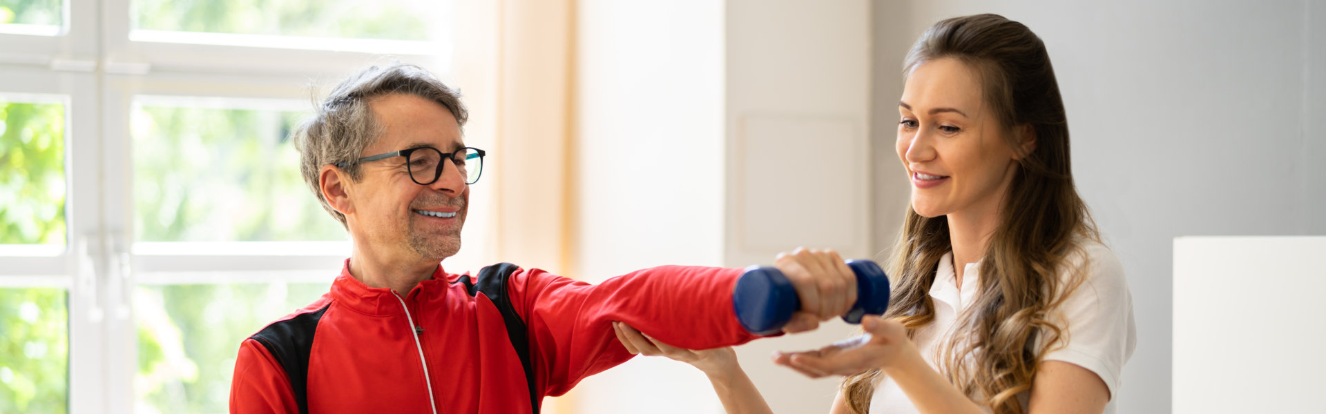 caregiver assessing the elderly man to exercise