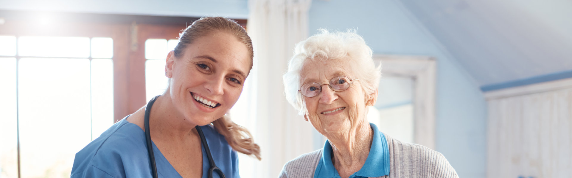 caregiver and elderly woman smiling